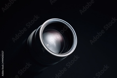 close-up of telescope lens against minimalistic dark background
