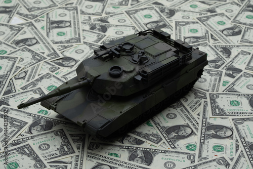 Obraz na płótnie War and money concept. Financial support war in Ukraine. Tank in military scene. Defense strategy. Money funding the attack. Financing war. Money becomes a weapon of war. Dollar as a symbol of power. w salonie