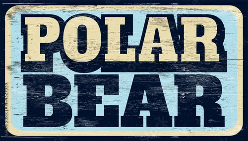 Aged and worn polar bear sign on wood