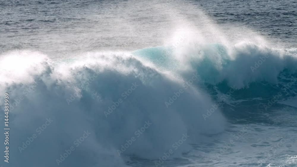 Dramatic ocean waves collide with the volcanic coastline near Timanfaya National Park, located on the island of Lanzarote in the Canary Islands, Spain.