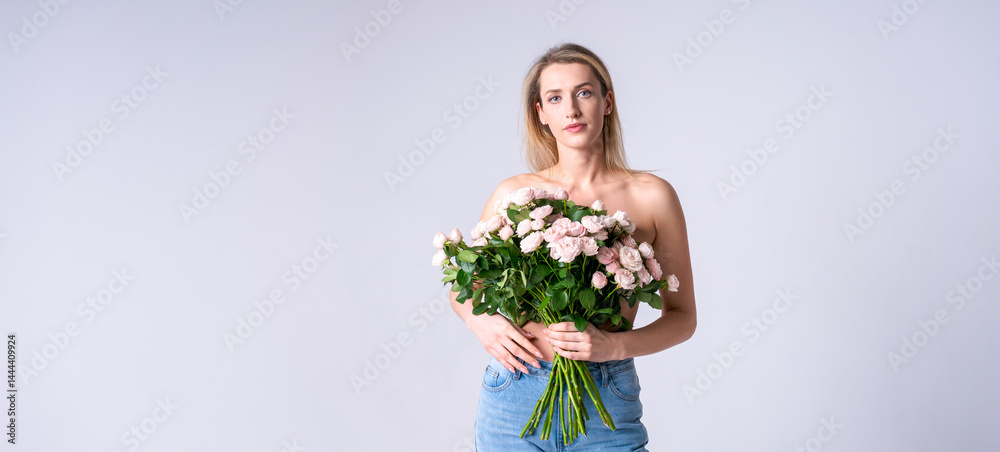 Stylish woman with a bouquet of roses on a light background, ideal for advertising fashionable clothes or accessories