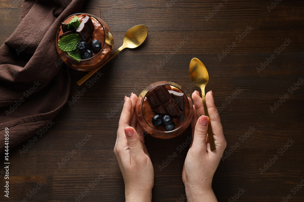 Chocolate mousse in a glass on a dark background.