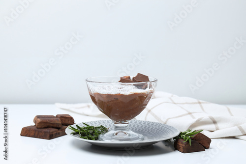 Chocolate mousse and ingredients on a light background.