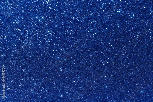 A shiny and sparkling dark blue glitter texture background with bright spots photo