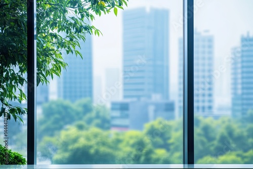 Cityscape view through a large window with greenery  Blurred city buildings and trees visible beyond the windowpane