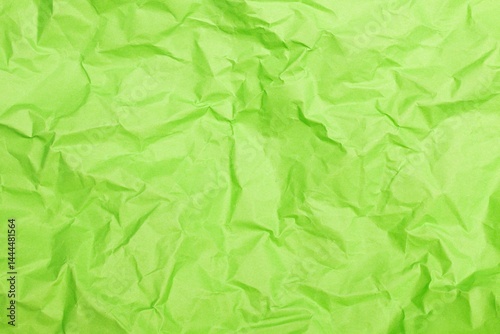 Close up shot of light green wrinkled paper creating an abstract background