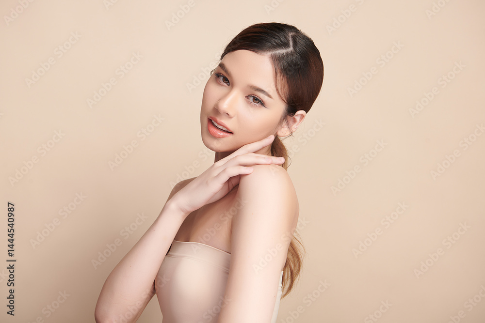 A beautiful young Asian woman with clean, fresh skin against a beige background. Skincare, facial treatment, cosmetology, beauty, and spa. An elegant portrait of an Asian woman. A beautiful young Asian woman with clean, fresh skin against a beige background. Skincare, facial treatment, cosmetology, beauty, and spa. An elegant portrait of an Asian woman.
