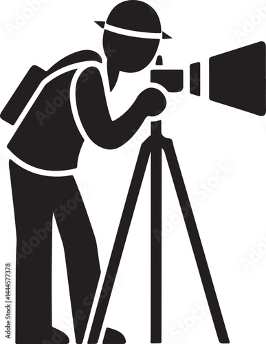 A black silhouette of a photographer with a camera on a tripod captures a photo in a studio