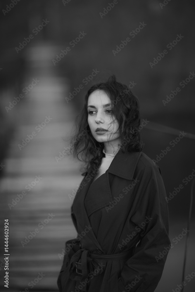 beautiful brunette european girl in blue trench coat at nature. Young lady with beautiful face.