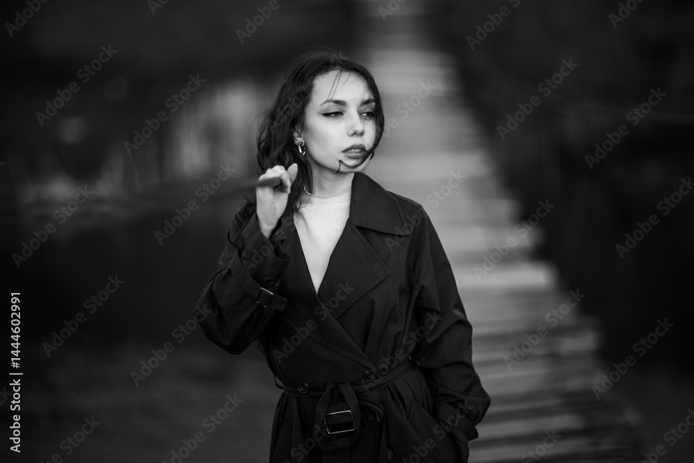 beautiful brunette european girl in blue trench coat at nature. Young lady with beautiful face.