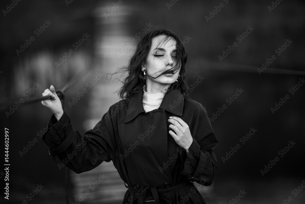 beautiful brunette european girl in blue trench coat at nature. Young lady with beautiful face.