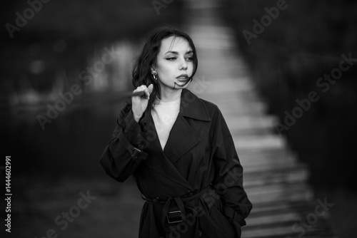 Obraz na płótnie beautiful brunette european girl in blue trench coat at nature. Young lady with beautiful face. w salonie