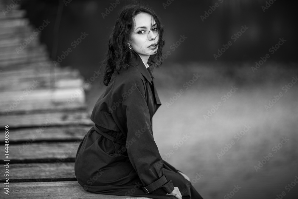 beautiful brunette european girl in blue trench coat at nature. Young lady with beautiful face.