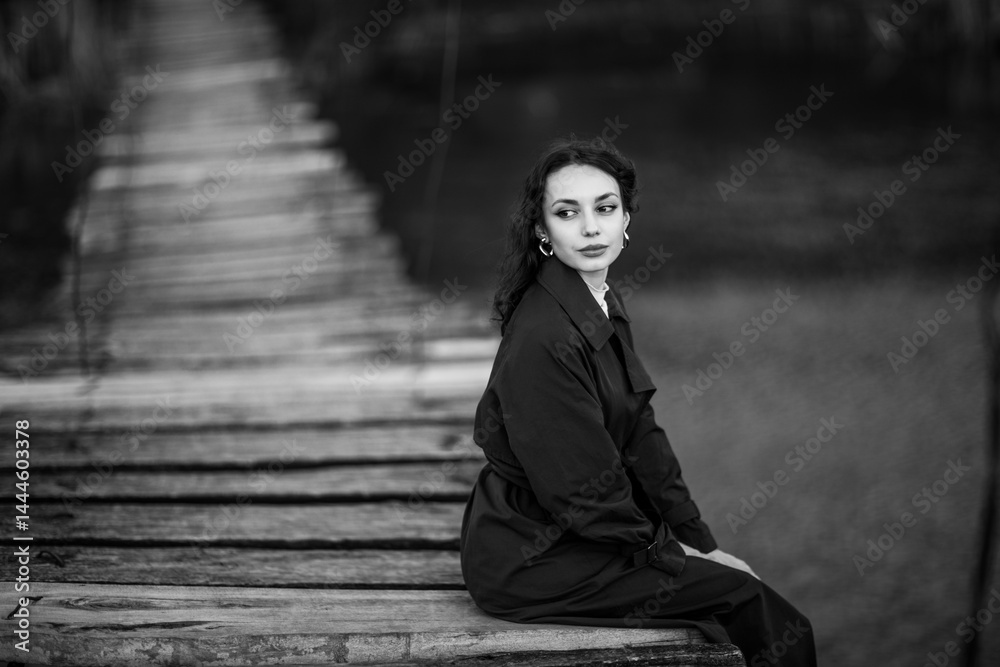 beautiful brunette european girl in blue trench coat at nature. Young lady with beautiful face.