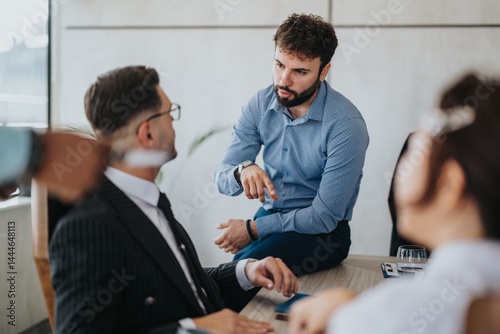 A group of diverse business people having a focused and dynamic meeting in an office setting, fostering teamwork and collaboration. photo