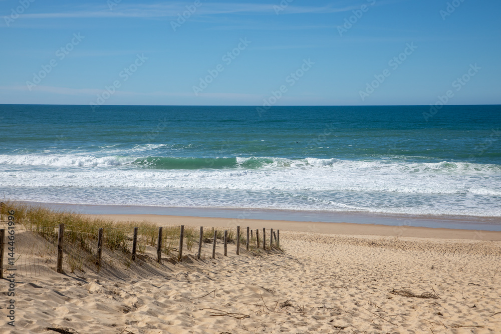 wooden fence on coast access sandy beach entrance to ocean atlantic sea in le grand crohot sand in lege cap-ferret