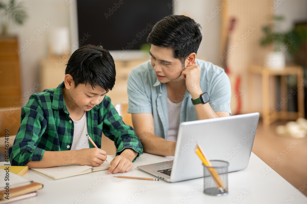 The father is teaching his son his homework with care at his home.