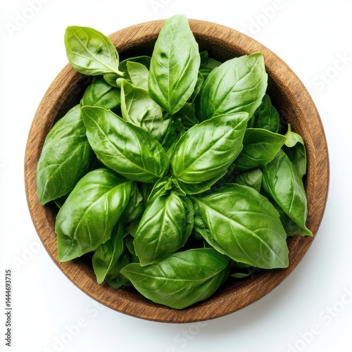 Fresh basil leaves in wooden bowl on white background