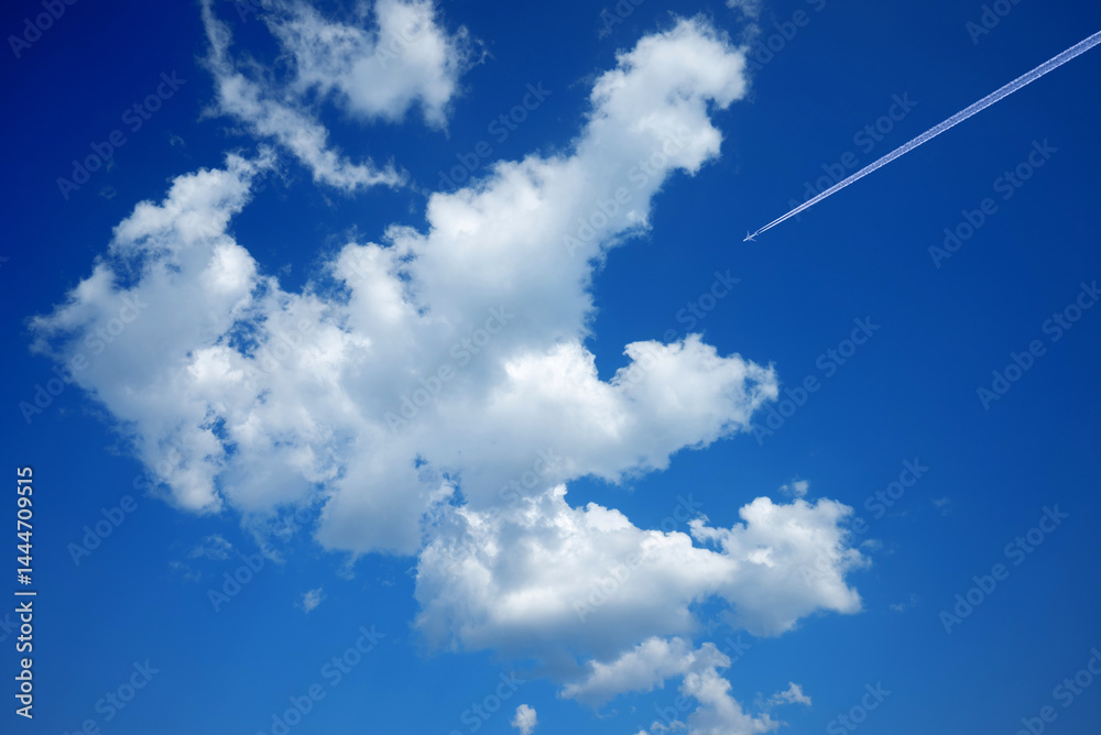 blue sky and white clouds with passenger plane in high altitude with vapour trail blue sky and white clouds with passenger plane in high altitude with vapour trail