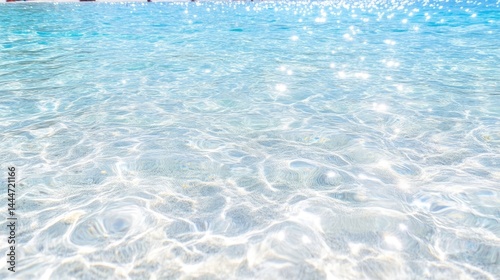 Sparkling, shallow, turquoise water. Sunlight reflects on rippled surface