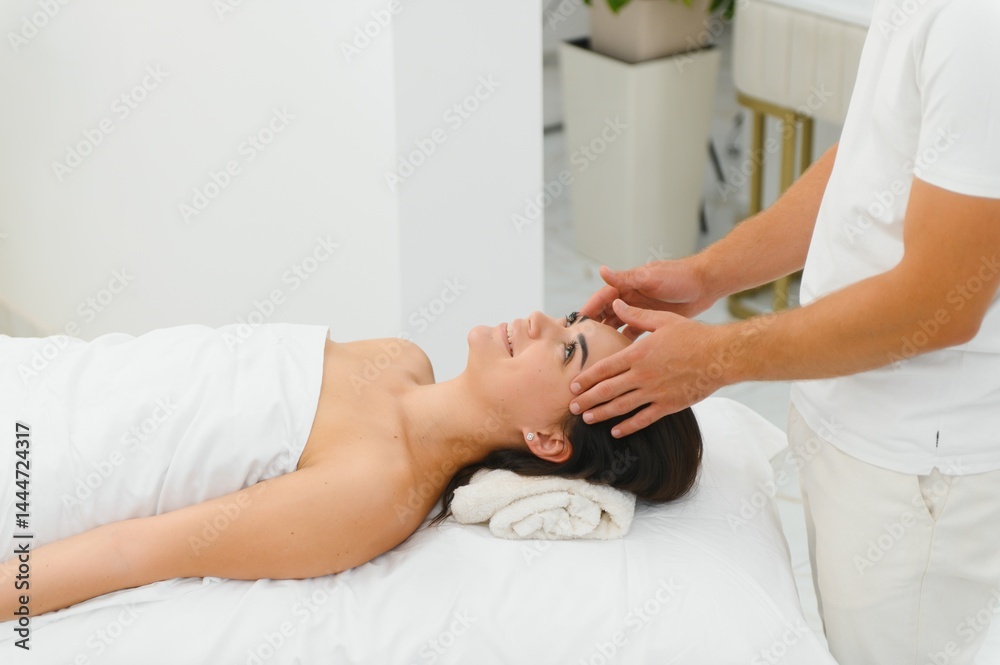 Fototapeta premium Theres no better way to relax. Shot of an attractive woman enjoying a face massage