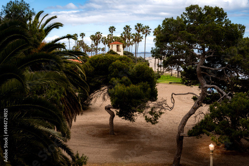 Tree lined beach with historical building in the background