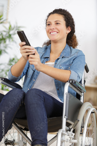 portrait of happy disabled woman watching tv at home