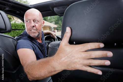 Obraz na płótnie mature man driver looking back and parking car w salonie