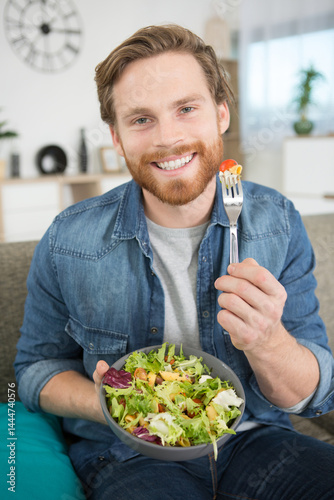 portrait of man eating a salad