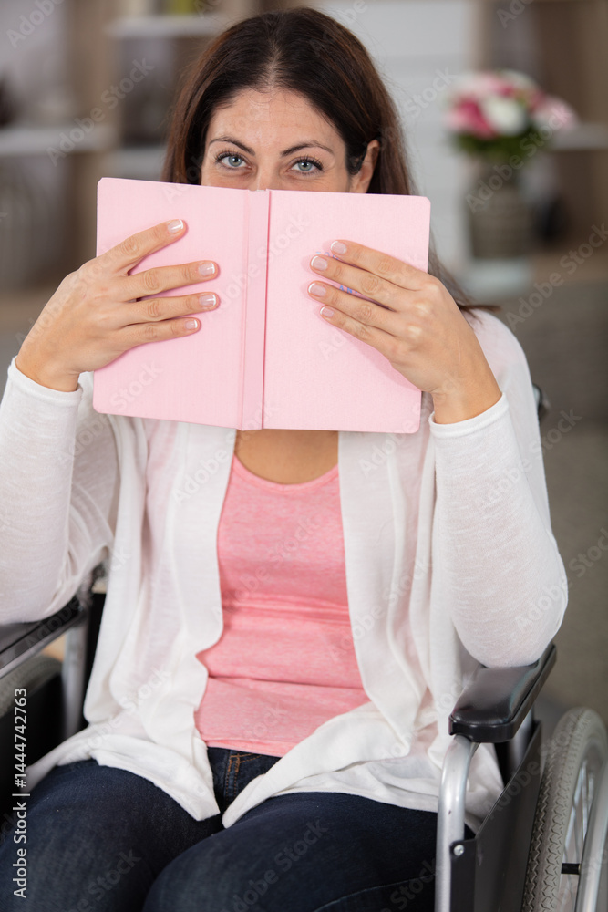 happy disabled handicapped woman sit on wheelchair reading