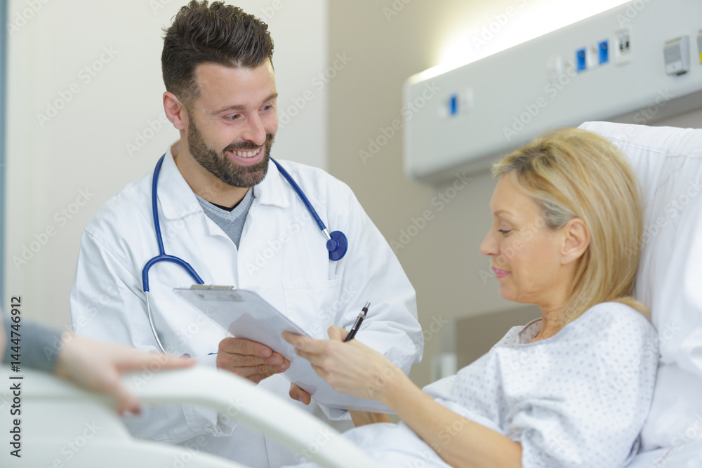 doctor talks to patient in hospital bed