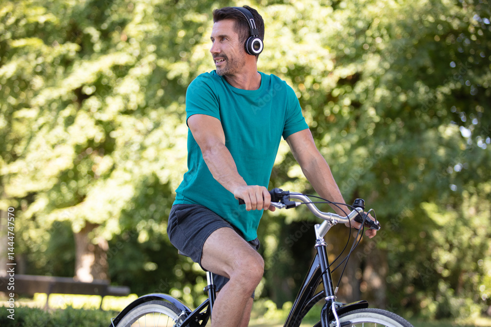 cheerful man sitting on the bike looking to the side