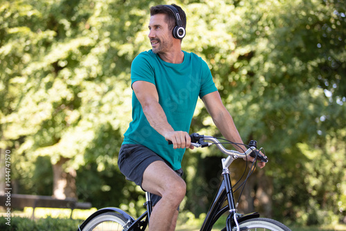 cheerful man sitting on the bike looking to the side