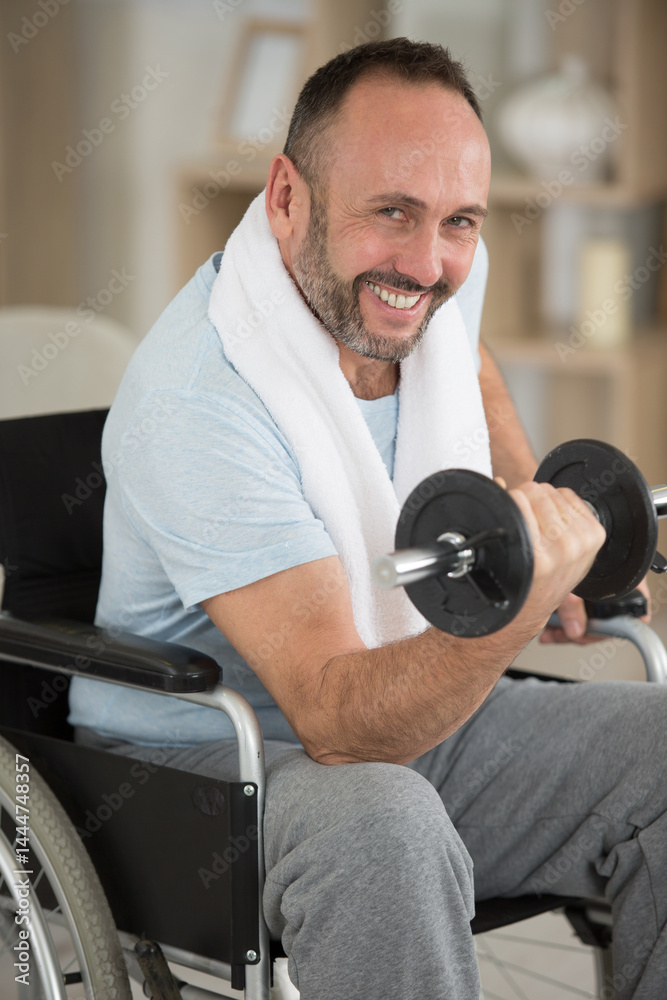 involved disabled man exercising with dumbbells