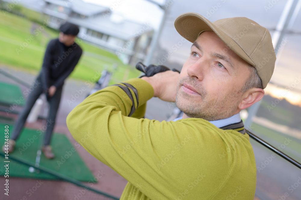 close up of golfer training inside