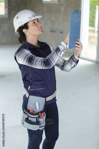 female builder with a clipboard