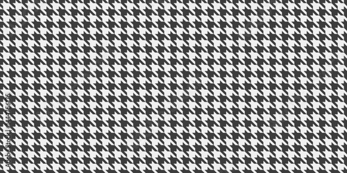 Classic houndstooth pattern in monochrome.  Elegant and versatile, ideal for textile design, fashion, website backgrounds, or print projects.  The repeating motif offers a timeless sophistication.
