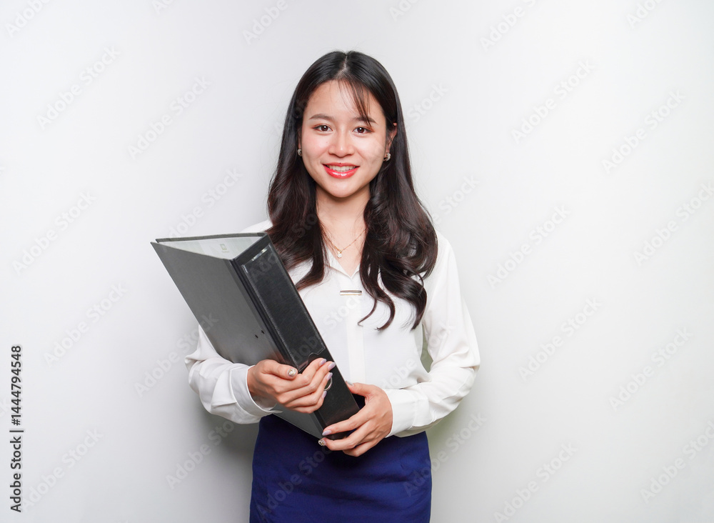 Businesswoman holding a file and smiling happily Businesswoman holding a file and smiling happily