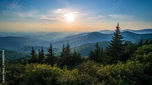 A mountain view with trees and mountain shapes against a blue sky. The sun is rising. Great for hiking and enjoying nature.
