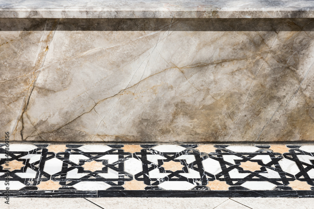 Close-up image showcasing a decorative marble wall and tiled floor