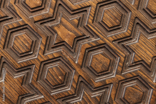 Obraz na płótnie Carved wooden texture featuring geometric patterns of stars and hexagons w salonie