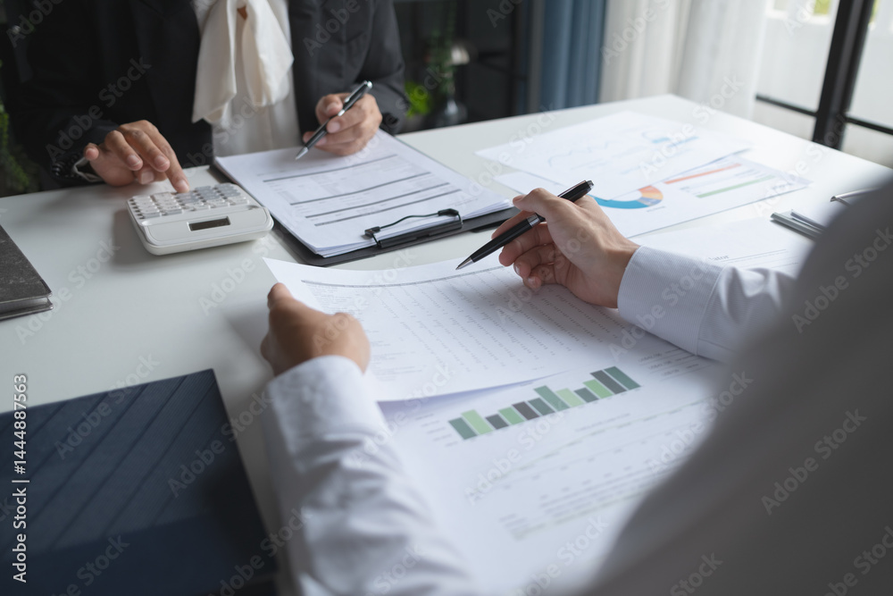 Financial inspector calculating a numbers in office room Financial inspector calculating a numbers in office room