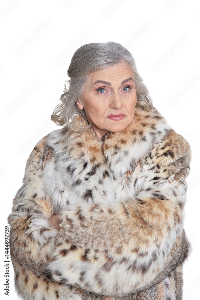 portrait of sad beautiful senior woman in fur coat