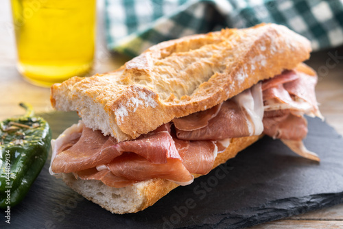 Photography Spanish serrano ham sandwich on wooden table