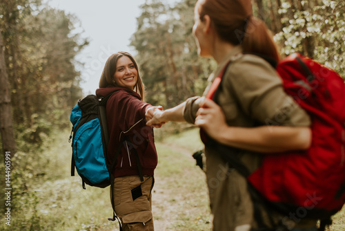 Two friends embark on an adventure in a tranquil forest during golden hour, sharing laughter and connection