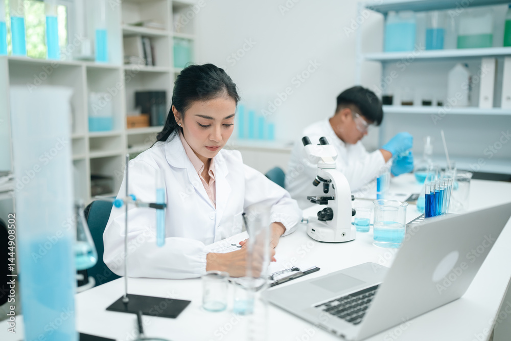 Modern medical scientists collaborate in a high-tech laboratory, analyzing chemical reactions and conducting precise experiments to advance healthcare and scientific research innovation