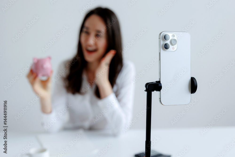 Feeling joyful while sharing a treat through smartphone video setup in a bright room during the afternoon
