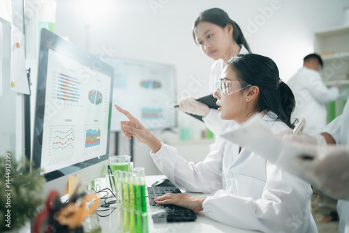 Wallpaper Mural Scientists analyzing data results on laboratory computer monitors, focusing on research, innovation, experiment, teamwork, and biotechnology in modern lab environments for scientific development Torontodigital.ca