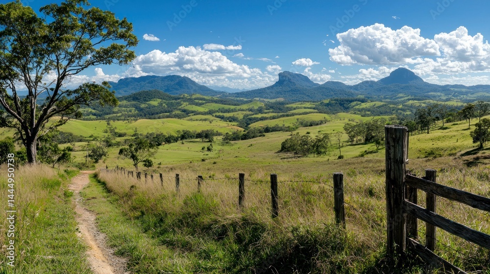 Scenic landscape view with hills mountains grass and a blue sky Scenic landscape view with hills mountains grass and a blue sky