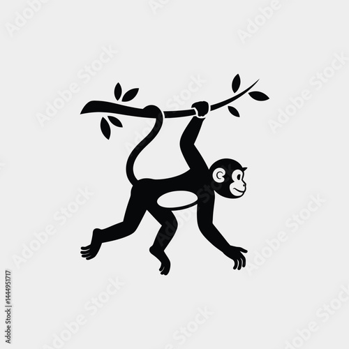 Silhouette of a Monkey Swinging from a Branch